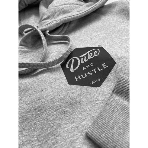 The Six Sider, Unisex Fleece Hoodie, front close up showing pocket print, cuffed sleeves, and draw strings