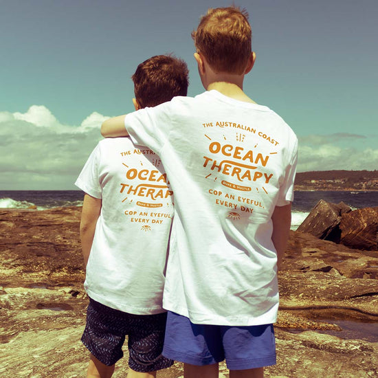 Two brothers model the Youth classic fit tee, featuring The Deep See design