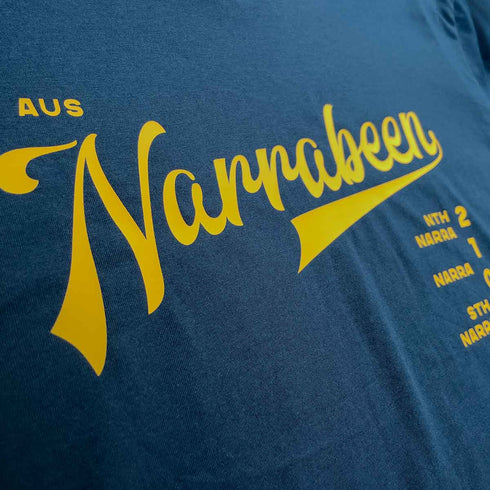 Narrabeen Beach Graphic Tee, dark yellow coloured print on Navy Long Sleeve Cotton T Shirt, close up of front chest