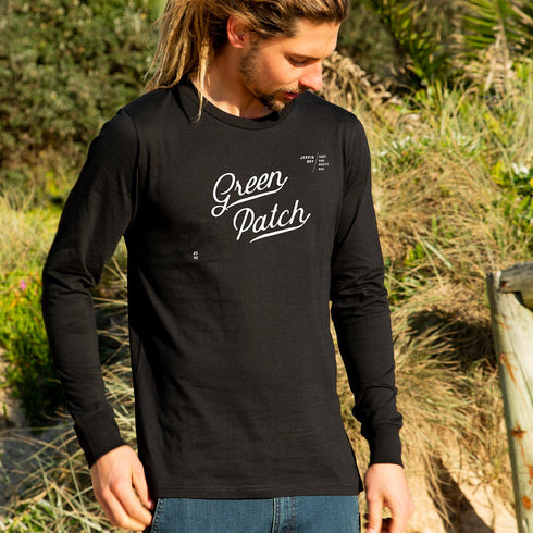 Ollie wearing the Green Patch Beach design on a black long sleeve cuffed tee