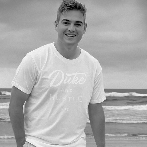 White Duke and Hustle Logo on white cotton, our classic fit t shirt "The Flat White", worn by Tim