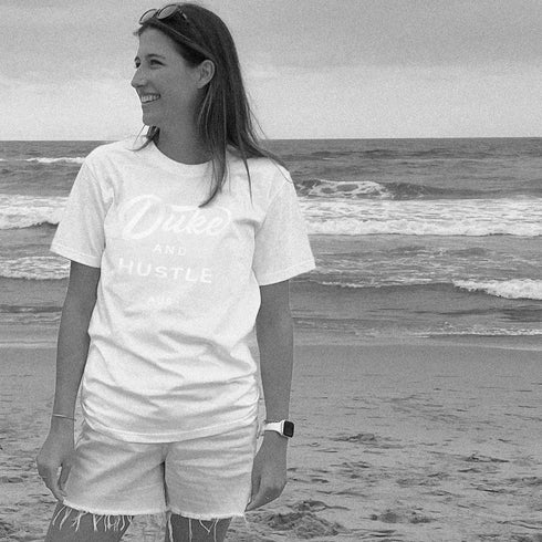 White Duke and Hustle Logo on white cotton, our classic fit t shirt "The Flat White", worn by Em